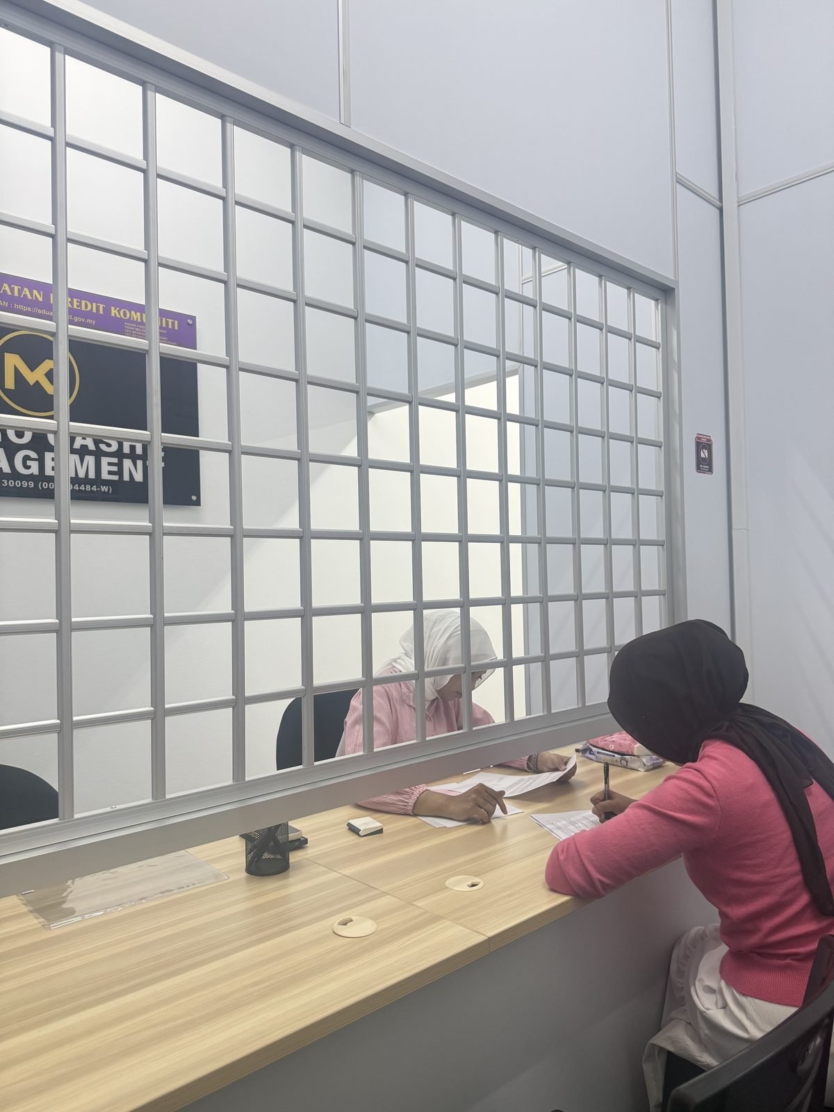 Metro Cashe Management office counter with a customer being served